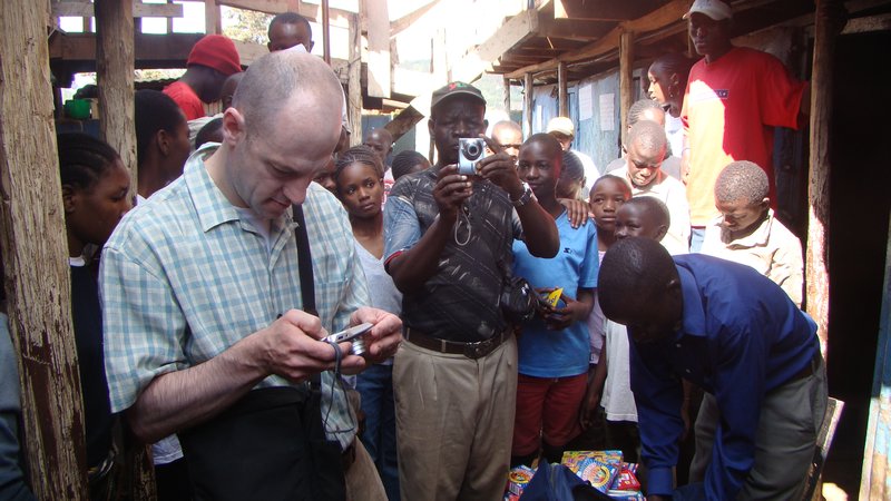 A US Accountant, Geoge Wolf, on a second visit to Kibera Slums donates books to Tunza children center