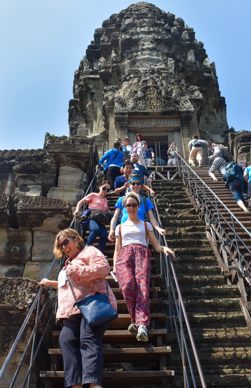 Climbing Down the Staircase from the Upper Level of Angkor Wat