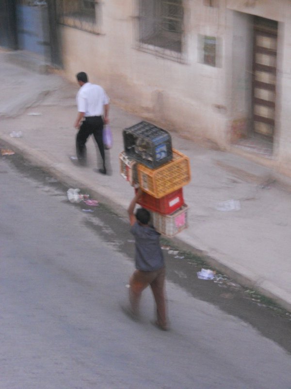 man carrying crates