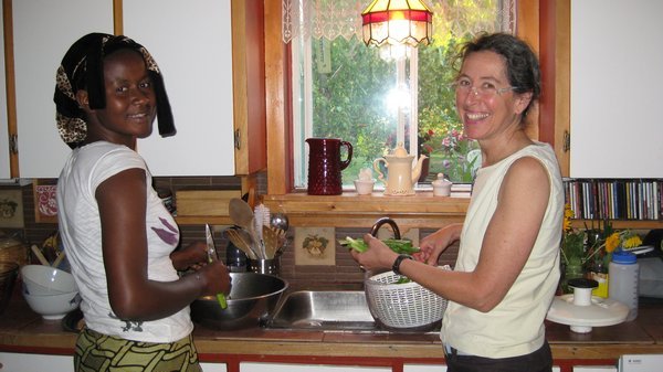 Mom and Sadio washing lettuce from the garden