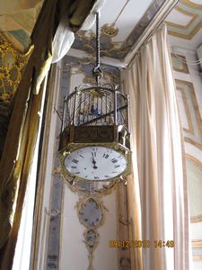 a bird cage/clock