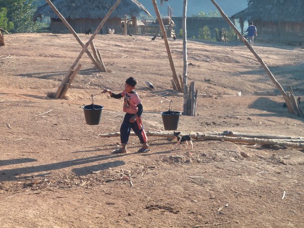 Boy carrying the water to our hut