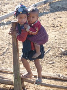 Akha kid carrying her baby brother