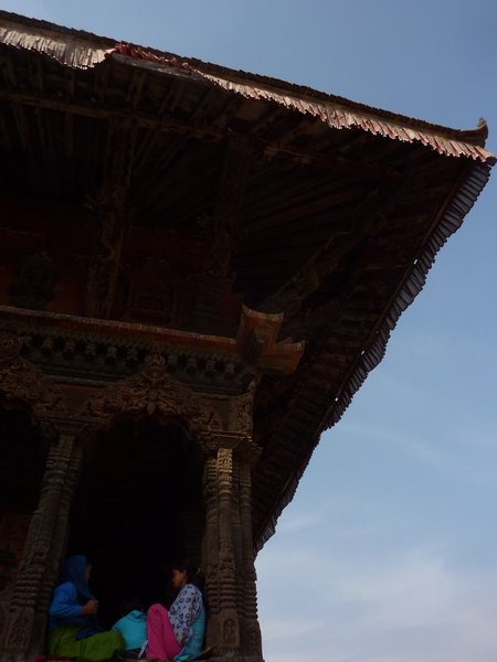 2 Nepalese ladies in the shade of a temple on Durbar Square Patan