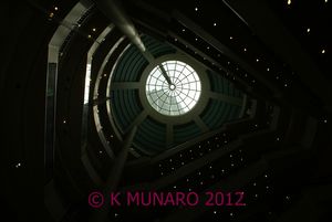 in the mall looking up to the top of towers