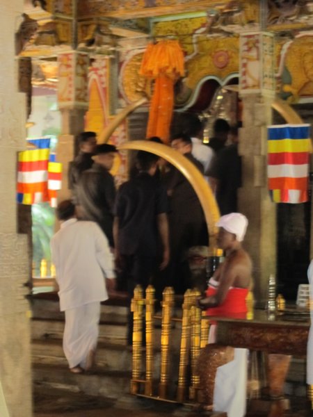 First Lady being whisked away into the temple chamber