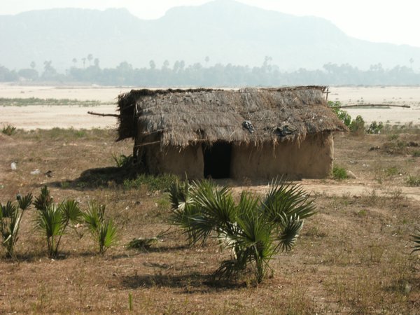 Thatched hut on the river bank