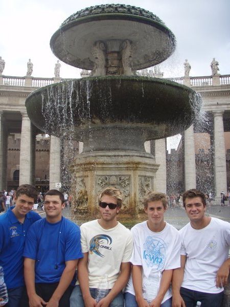 Adam, Dylan, James Mc., Mark and PJ in front of the fountain in St. Peter's Square