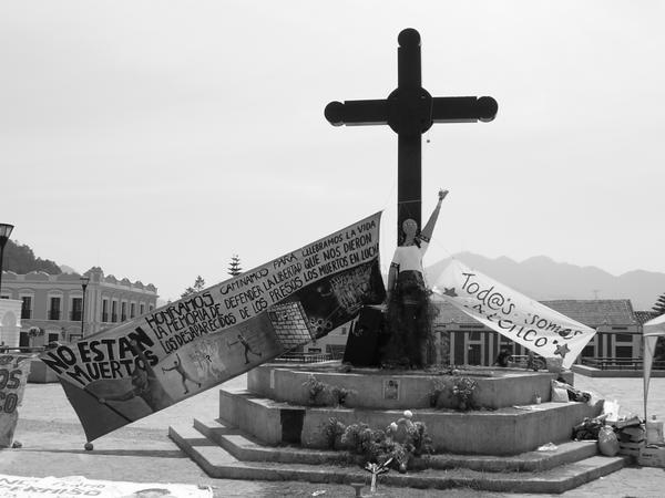Cross at Central Square with mothers day figure and Zapatista Poster