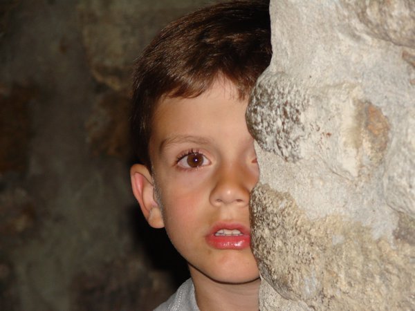 Ayden peeking around a wall in Split's old town.