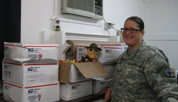 The mail room Sergeant and Dobie with all the boxes of candy! 