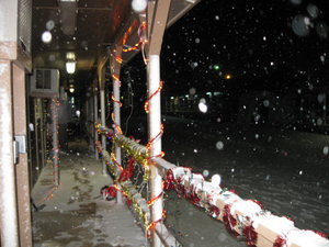 Snow falling on the decorations on our deck