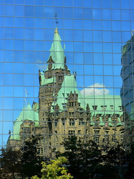 Parliament building's reflection in an office tower