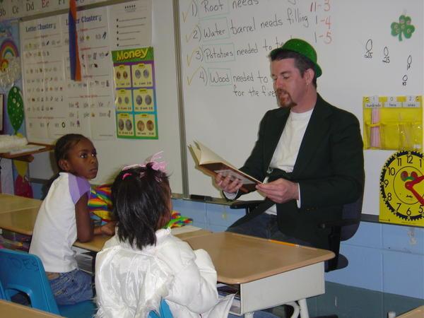 Noel reads to a 1st grade class