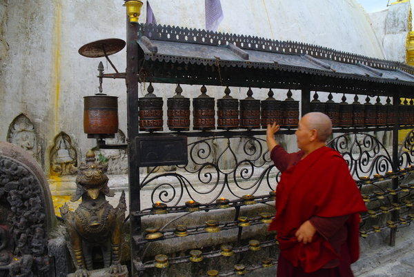 Monk at the prayer wheels