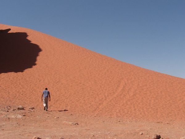 Amil climbing a sand dune