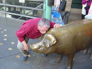 Bob is kissing the pig for luck