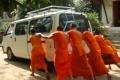 Novice monks pushing a van to start