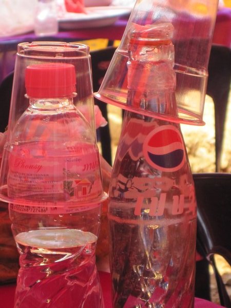 Table bottles of water and homemade lao-lao whiskey