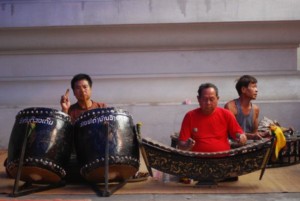 Men playing traditional Lao music at a temple festival