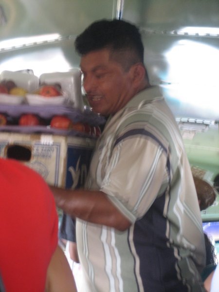 guy selling stuff on the chicken bus