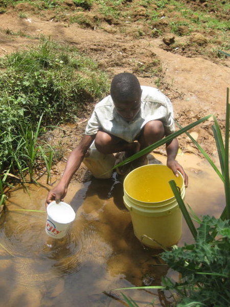 Fetching water to bring to school from the river