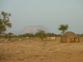 A small Village with Mount Hombori in the back