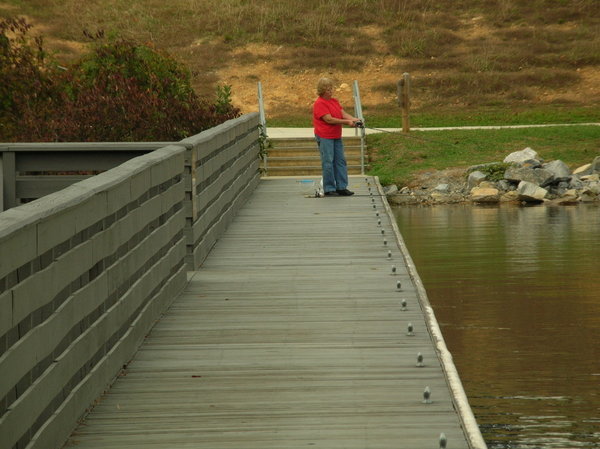 Lady fishing off the dock