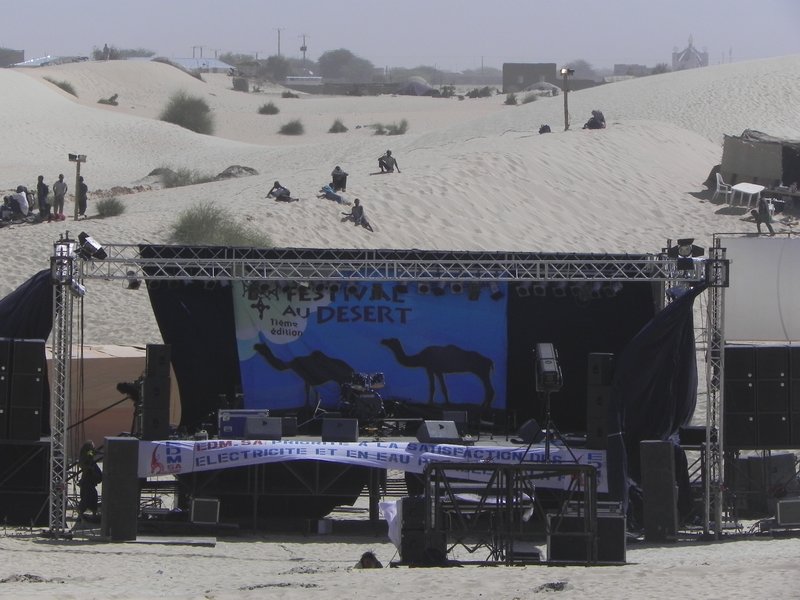 Stage for the festival surrounded on all sides by sand dunes.