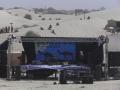Stage for the festival surrounded on all sides by sand dunes.