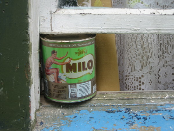 An Old Milo Tin Props Open a Window of the House where Baxter established his Community