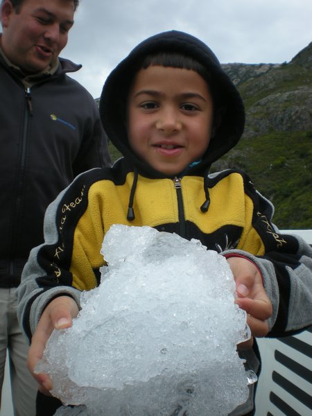 Omer holding a piece of ice