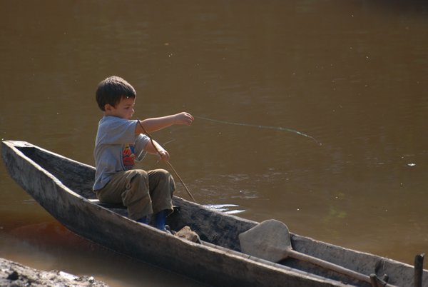 Shachar fishing from the canoe