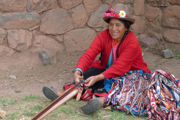 Woman weaving a belt