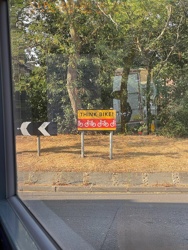 A Sign Seen While Looking Out the Bus Window