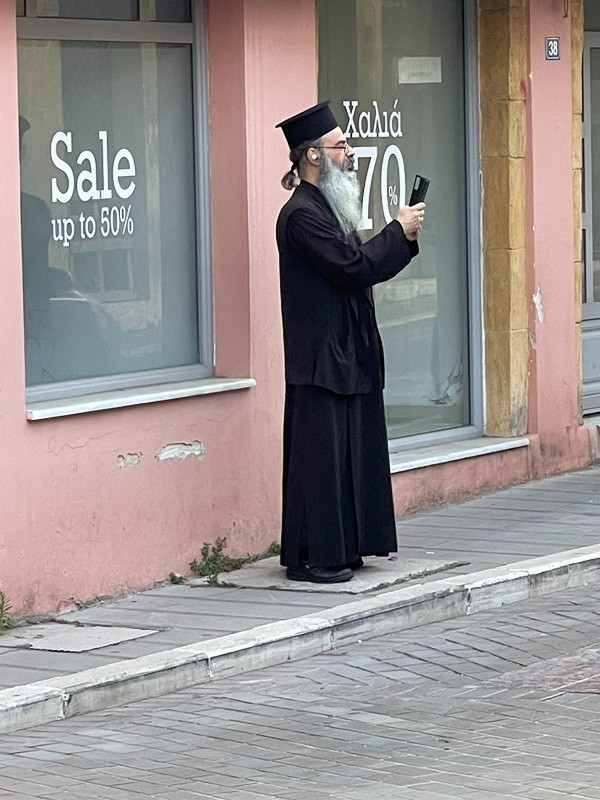 What is This Greek Orthodox Priest Taking Photo Of?