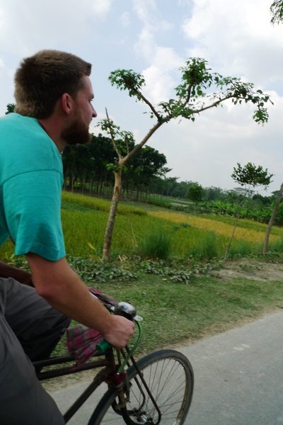 Tom tries to save us a Taka or two and rides our rickshaw to Rangur - Rajshahi
