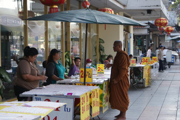 Monk buying a lottery ticket
