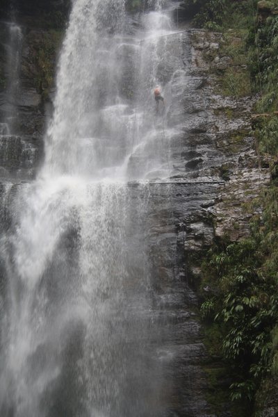 Sharman rapelling a waterfall
