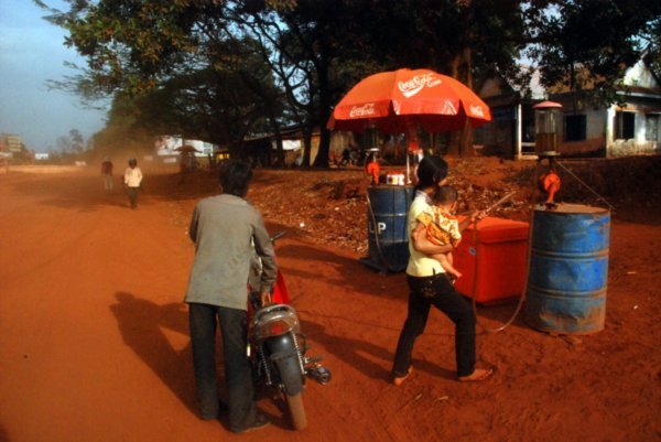 Everything in Ratanakiri is RED.  Gas Station mom with infant!