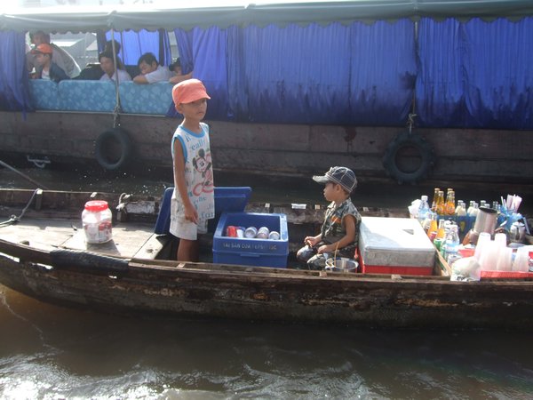 kids selling drinks to tourist:(((
