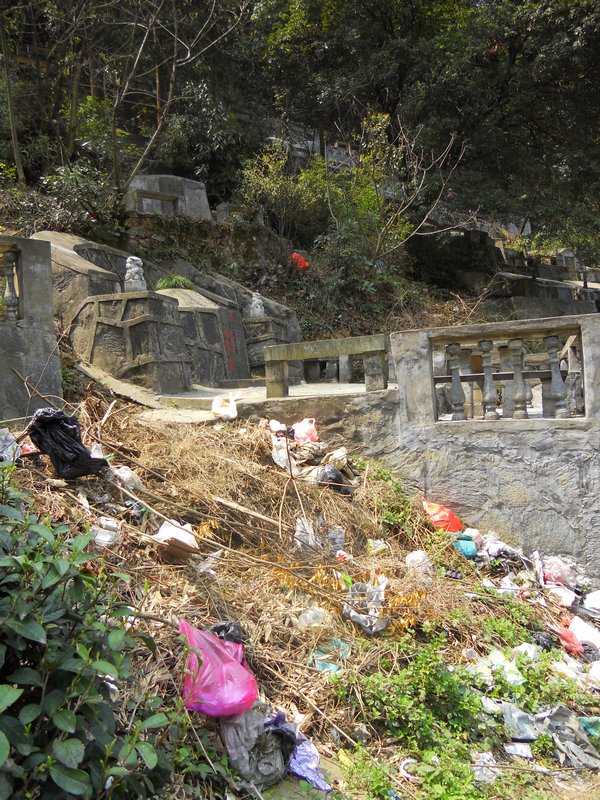 trash next to the graves that just were cleaned for Tomb Sweeping Holiday