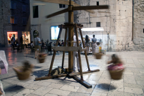 Children on hand-cranked swing in Split