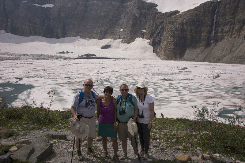 Hikers in front of Grinnell Glacier and lake