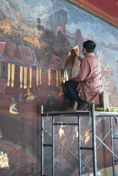 Painter restoring the murals