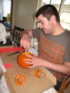 Ben carving a pumpkin