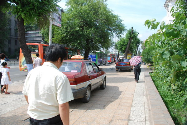 but just to proove we are still in China these cars are driving down the pavement