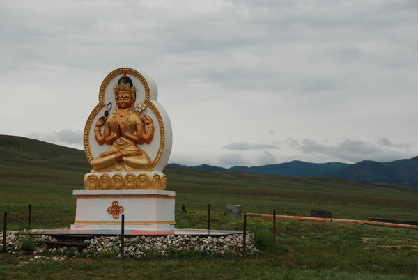 Buddhist stupas and statues are scattered randomly across the landscape