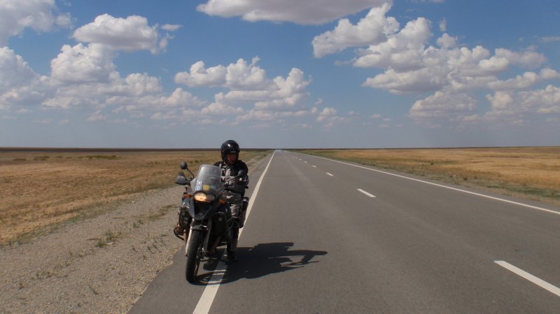  long, straight roads run for miles and miles across the flat Kazakh Steppe 