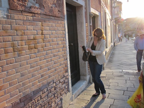 E in the middle of Venice partly barefoot with dog poop on her shoe...classic.